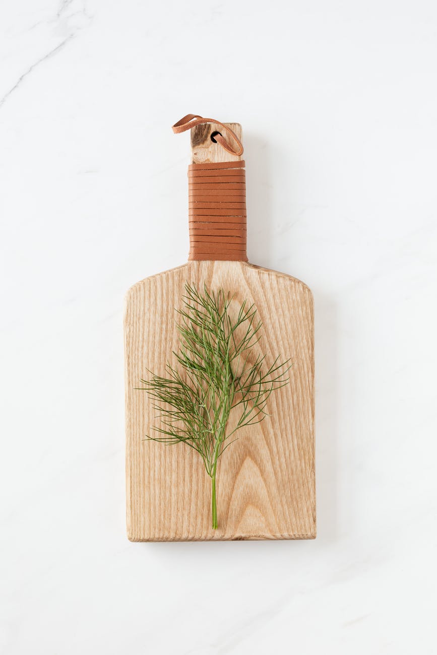 fresh green dill on wooden board