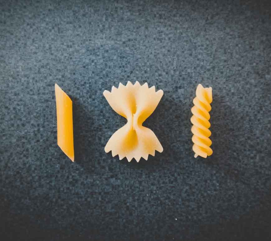 three different pieces of macaronis on top of black surface