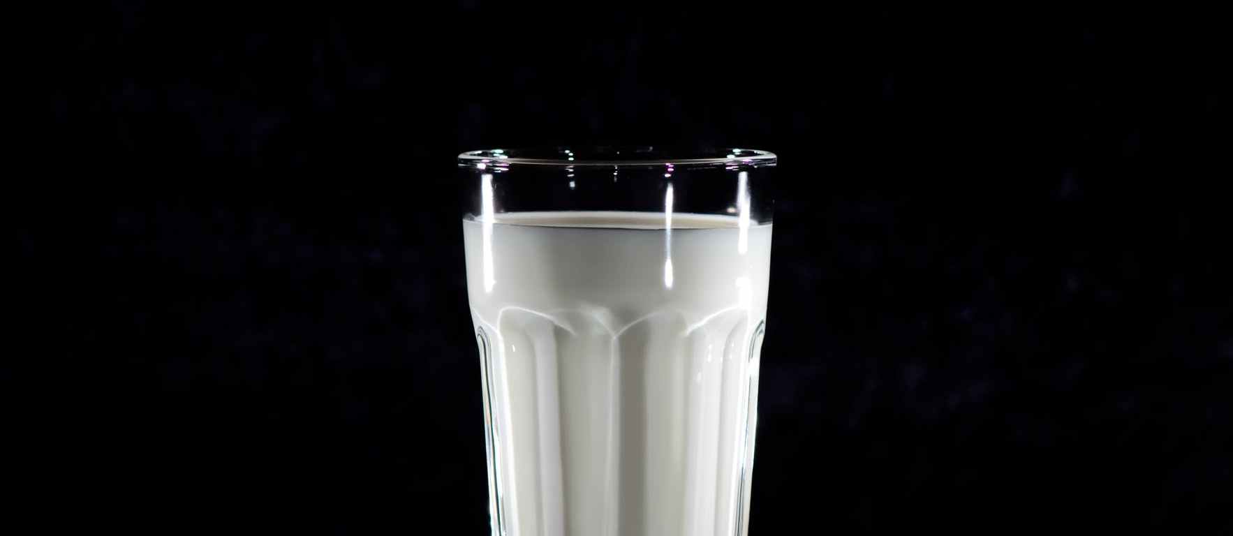 grayscale photography of glass of milk
