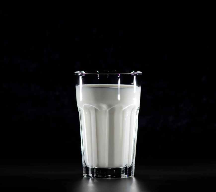 grayscale photography of glass of milk