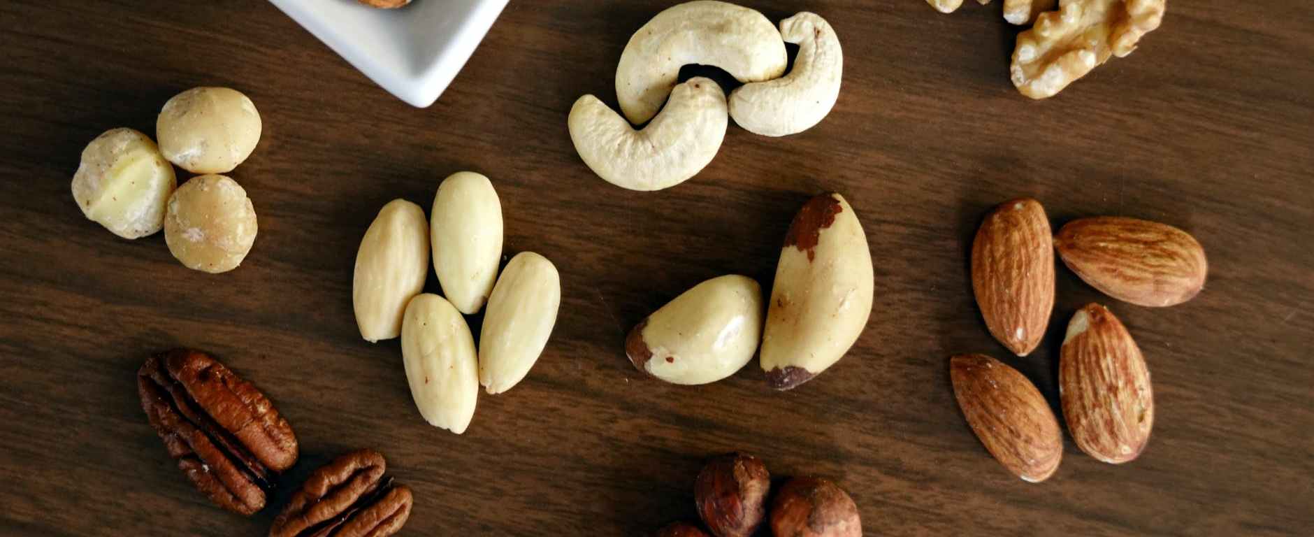 variety of brown nuts on brown wooden panel high angle photo
