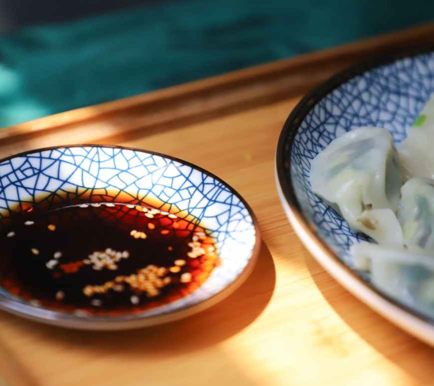 round blue saucer filled with soy sauce